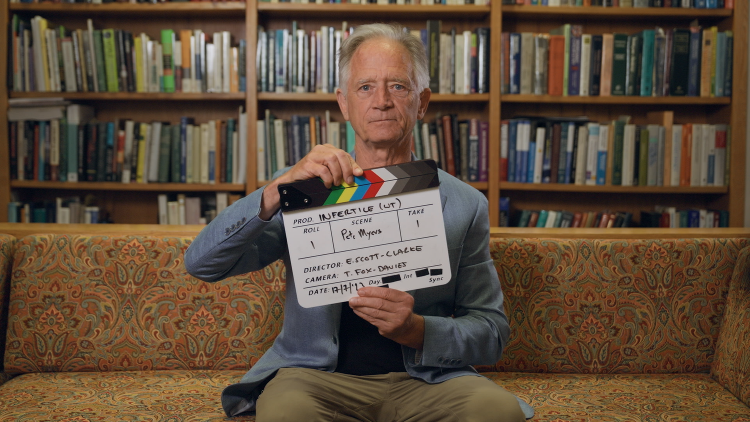Pete Myers holding an Infertile film slate during a documentary interview
